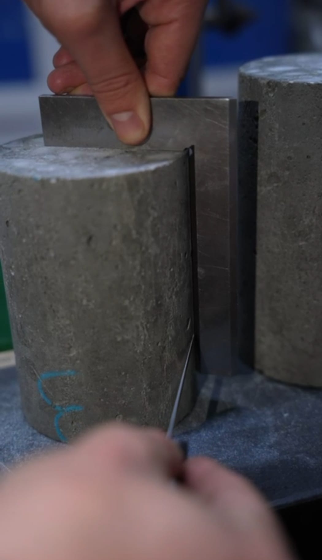 Technician checking rock core specimen flatness and alignment during sample preparation