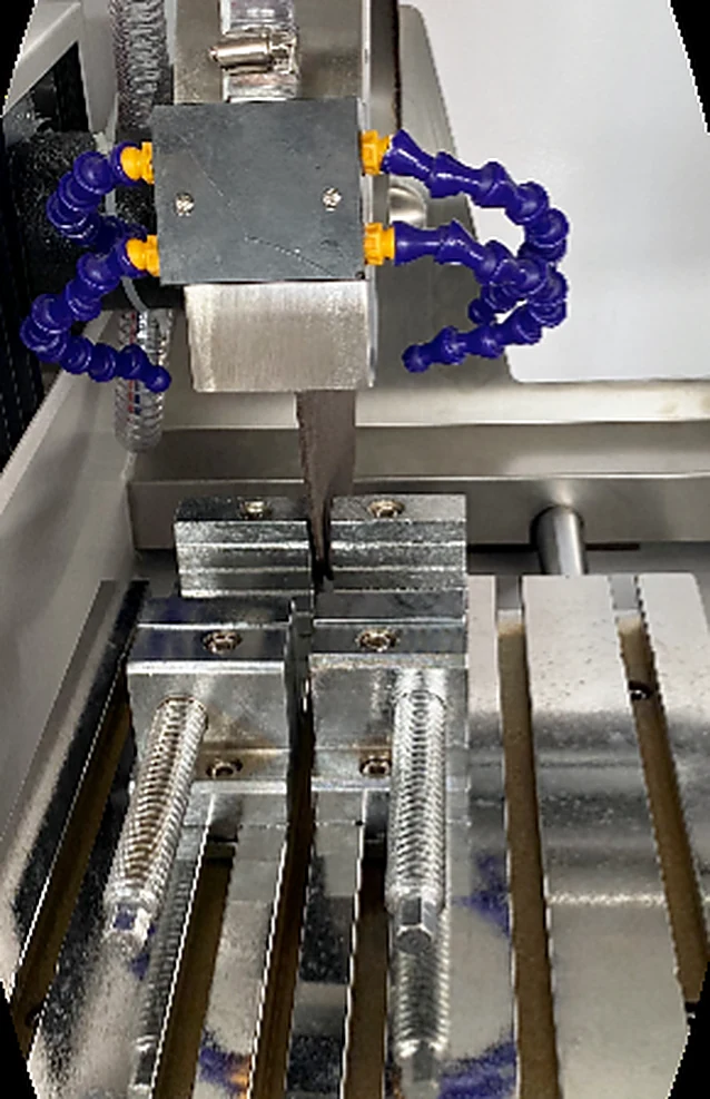 Fast clamps, coolant nozzles and the cutting wheel inside the GenCut GL100M chamber