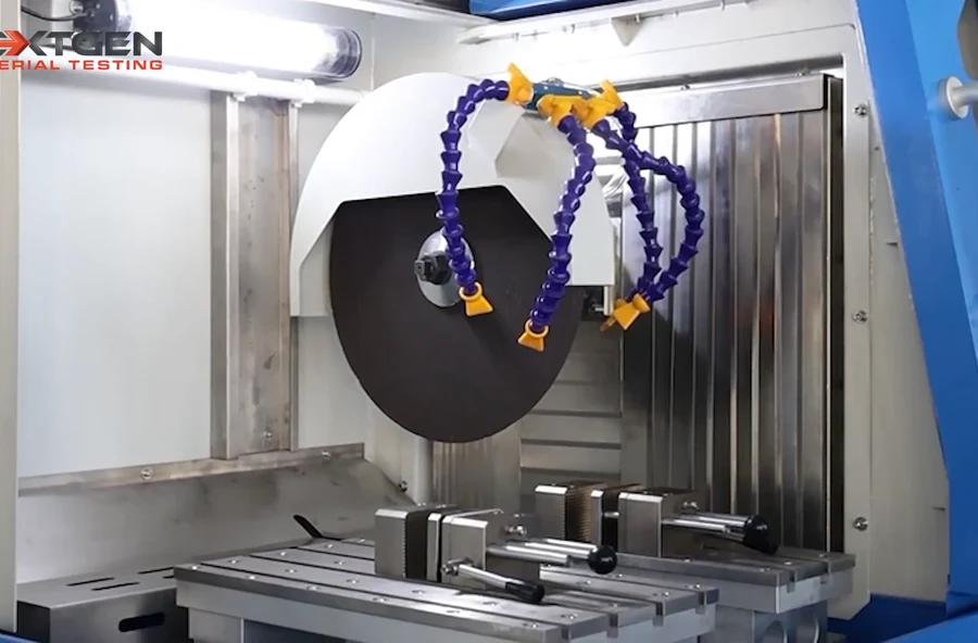 Cutting wheel, twin coolant nozzles and vise clamps inside the GenCut GL 120XY chamber