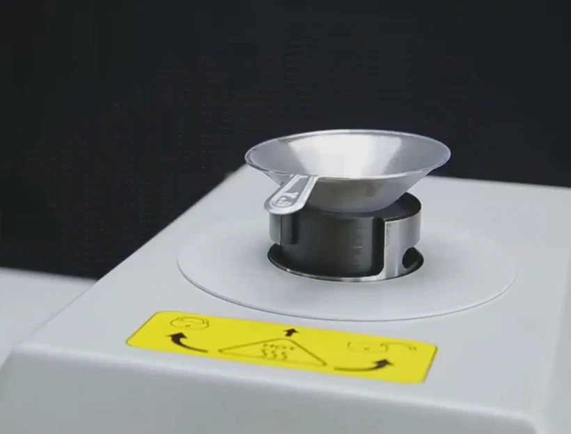 Funnel and powder spoon on the open mold of the GenPress MFA mounting press