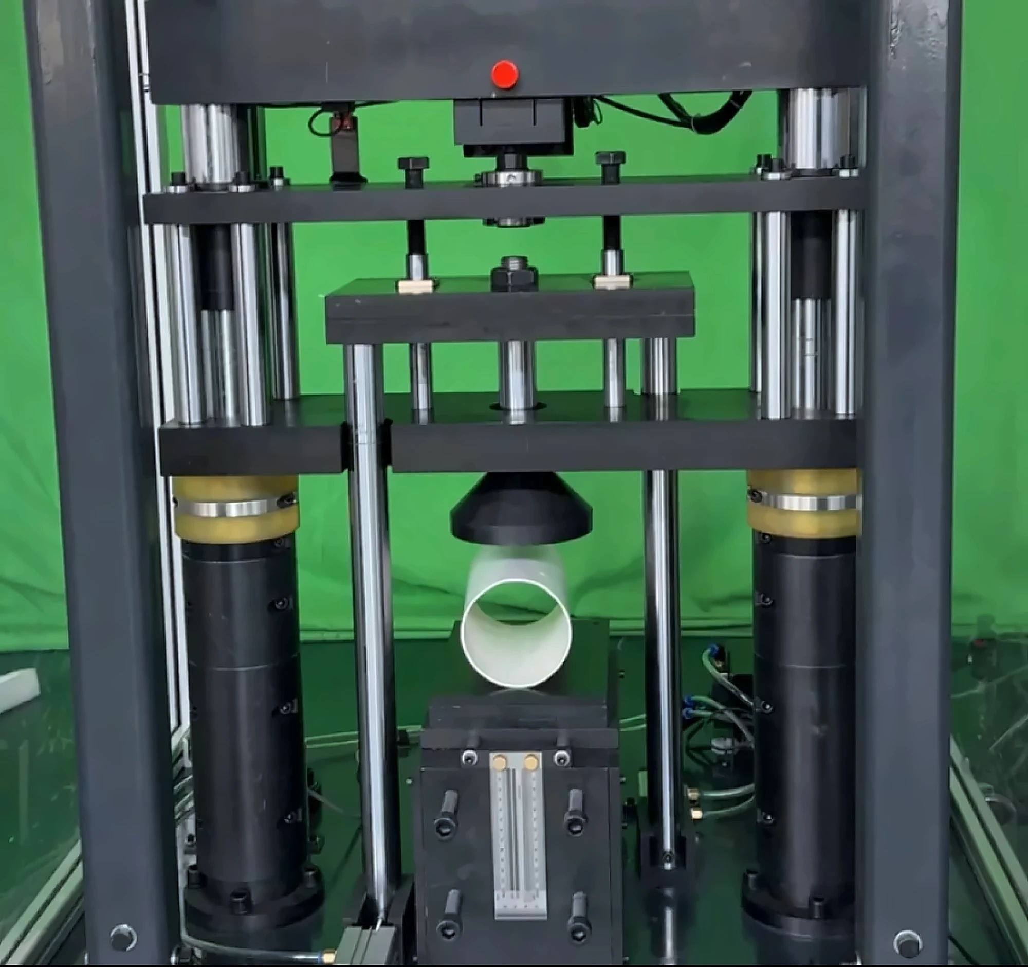 DWT-1800 impact zone with the round hammer about to strike a PVC pipe specimen
