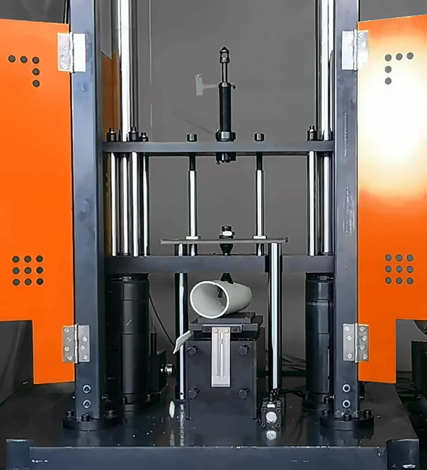 UL hammer striking a PVC pipe specimen inside the DWT-1800 impact frame